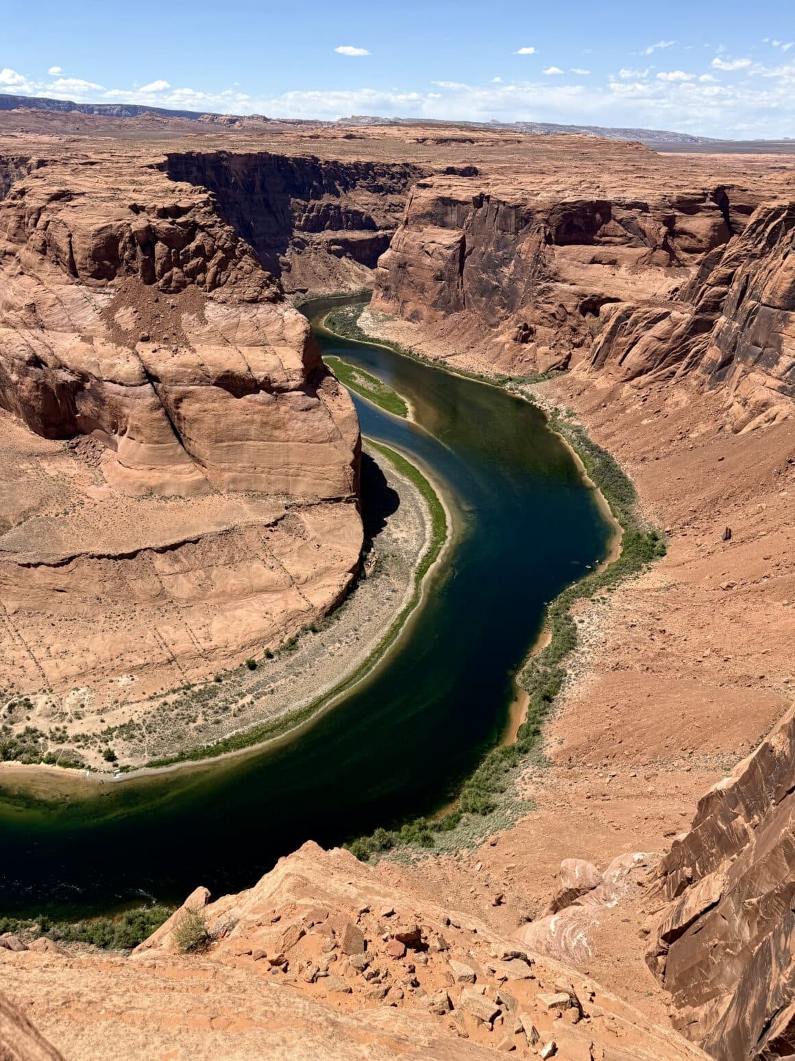 Colorado robi tu 270° eleganckiego skrętu. W słońcu skała błyszczy jak miedź, a cień klifu maluje na rzece półksiężyc. Geologia w wersji premium.